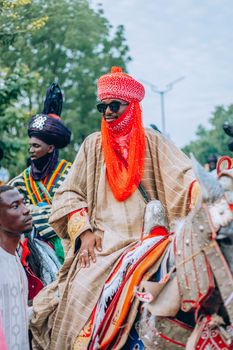 Vibrant cultural parade featuring traditionally dressed horsemen.