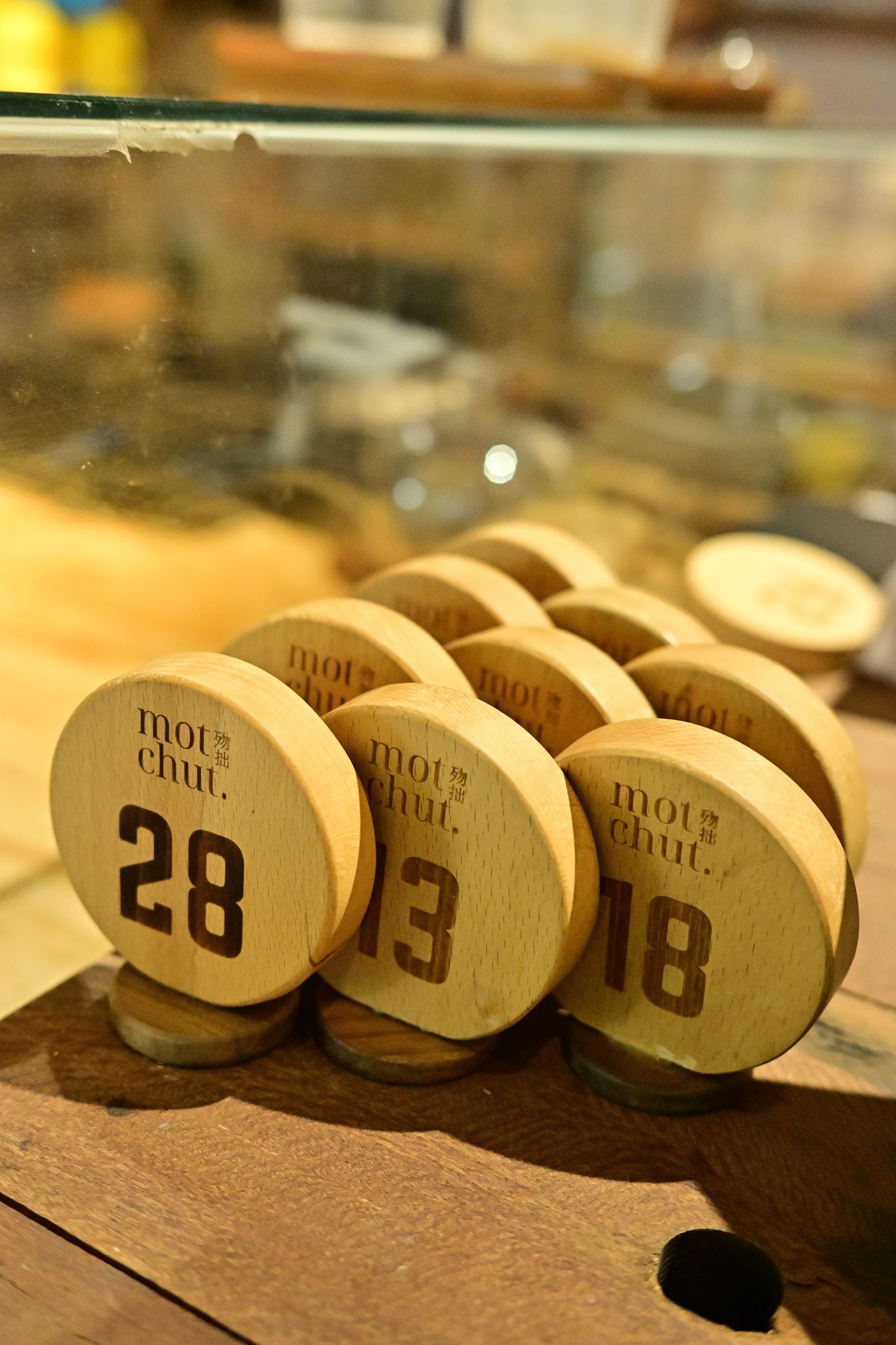 Wooden table numbers at a cafe counter, providing a rustic aesthetic.