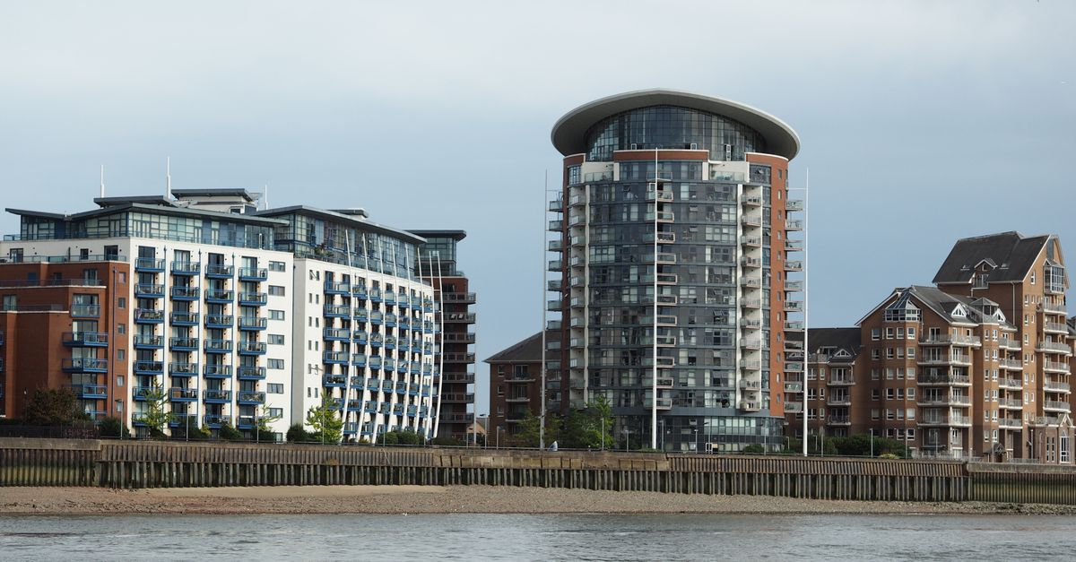 Striking modern riverside apartments showcasing unique architectural styles and glass facades.
