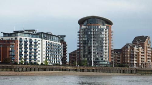 Free Striking modern riverside apartments showcasing unique architectural styles and glass facades. Stock Photo