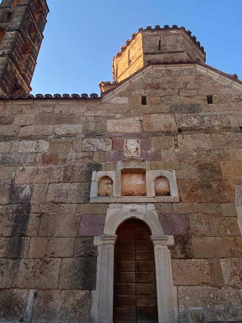 Free Ancient stone structure with architectural details, bathed in sunlight. Stock Photo