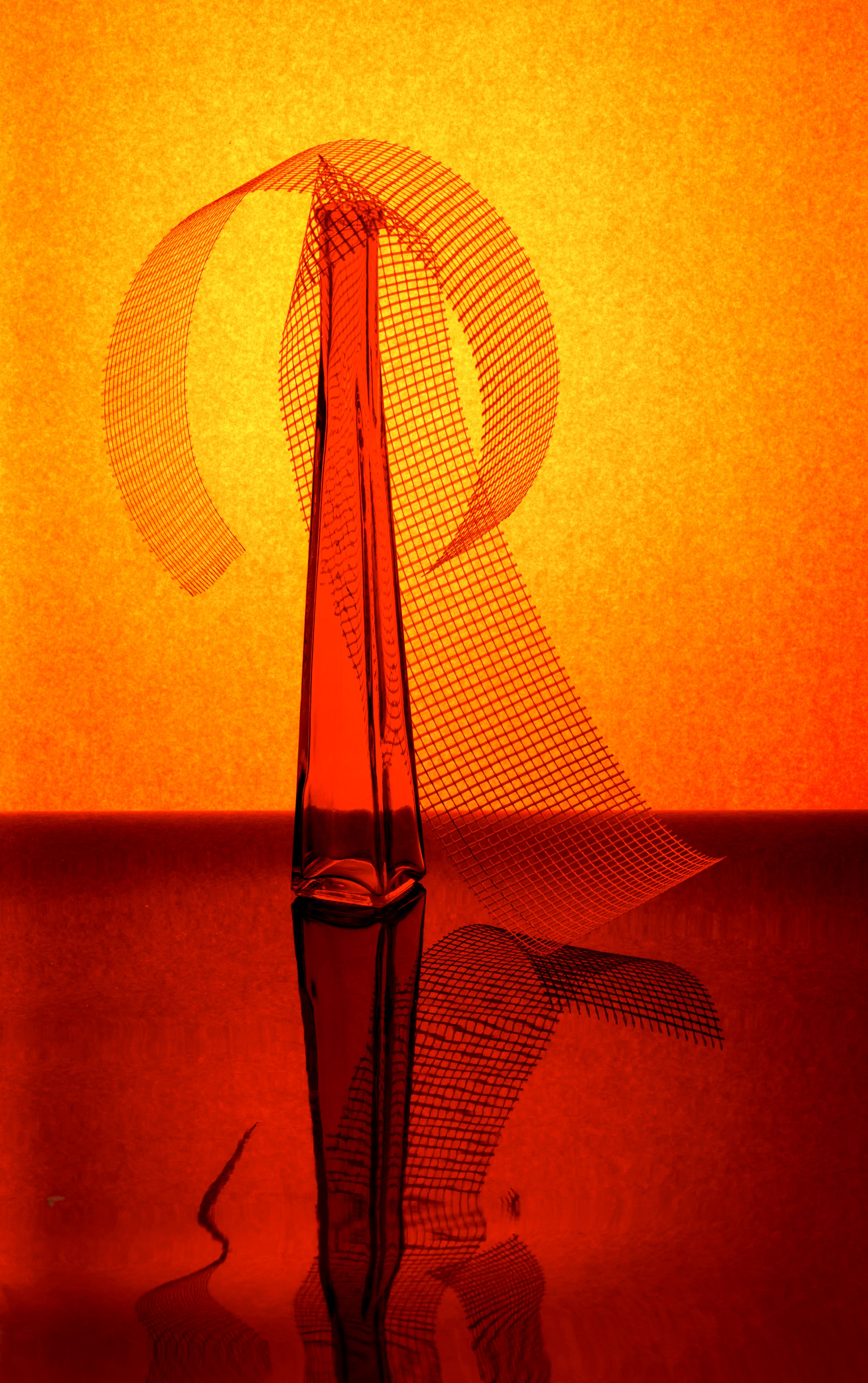 Artistic abstract red sculpture with orange backdrop creating vivid visual contrast.