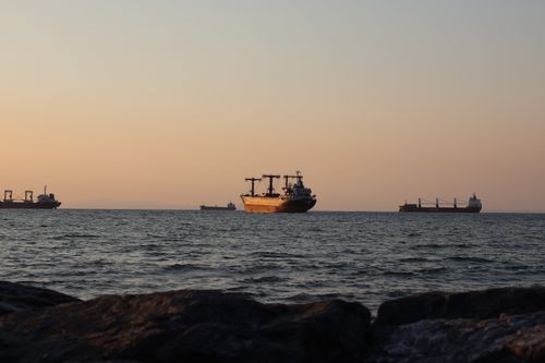 Free Serene view of cargo ships sailing on İskenderun Bay at sunset, capturing the tranquil evening atmosphere. Stock Photo