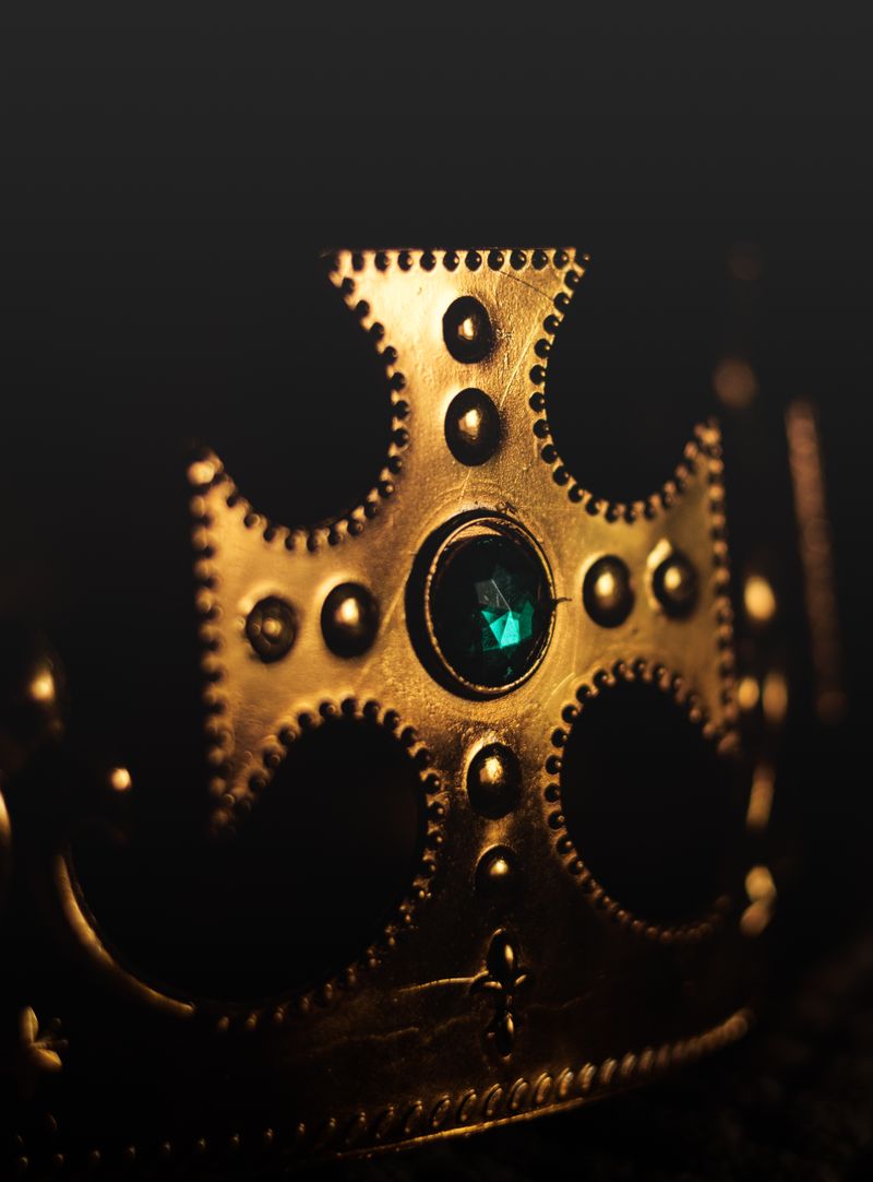 Golden crown adorned with a blue gemstone