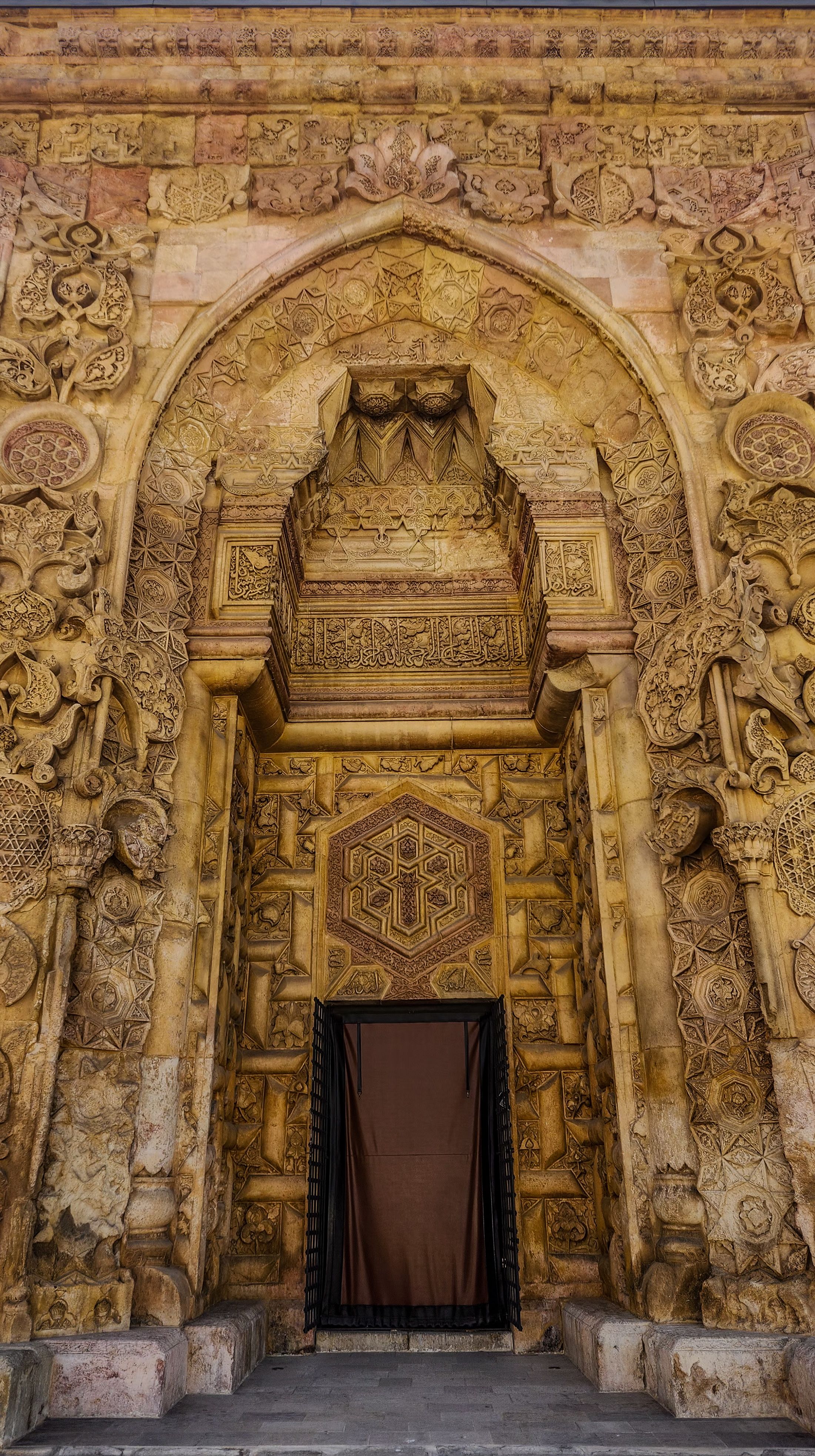 Exquisite stone-carved doorway with intricate designs on historic building.