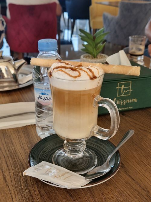Free A delicious latte topped with a biscuit stick in a Moroccan cafe setting. Stock Photo