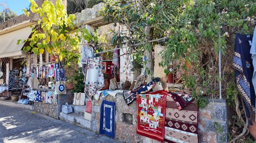 Free Colorful textiles and crafts displayed outdoors in Krasi, Greece, surrounded by lush greenery. Stock Photo