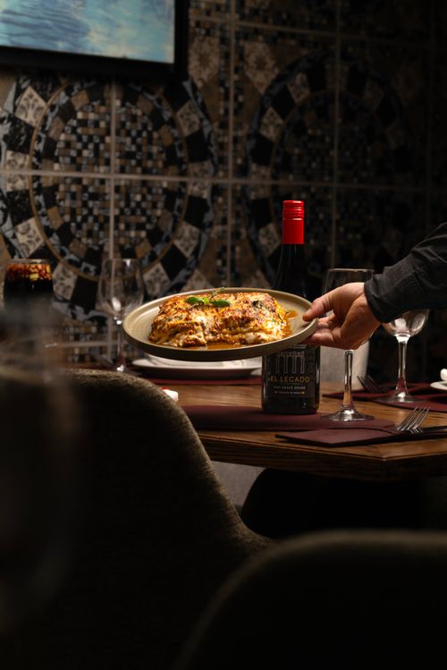 Free Cozy restaurant scene featuring delicious pasta served with red wine. Stock Photo