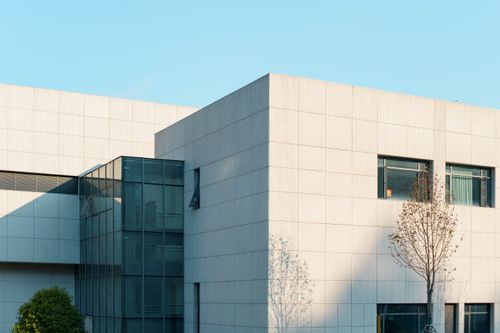 Free A modern building with a glass facade and minimalist design, perfect for architectural themes. Stock Photo