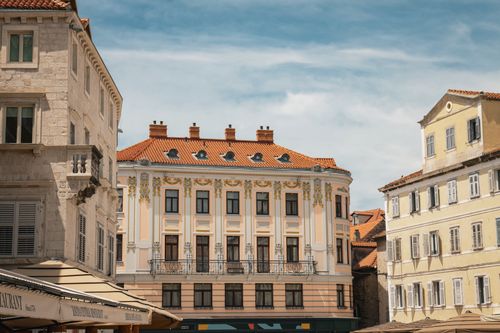 Free Ornate historic buildings in a vibrant square in Split, Croatia, showcasing European architectural style. Stock Photo