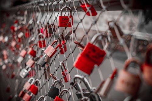 Free Red Padlock on Cyclone Fence Stock Photo