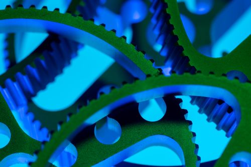 Free Vibrant macro shot of green and blue interlocking gears showcasing precision engineering. Stock Photo