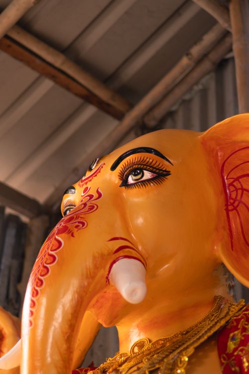 Free A detailed close-up of a colorful Lord Ganesha statue indoors, emphasizing intricate details. Stock Photo