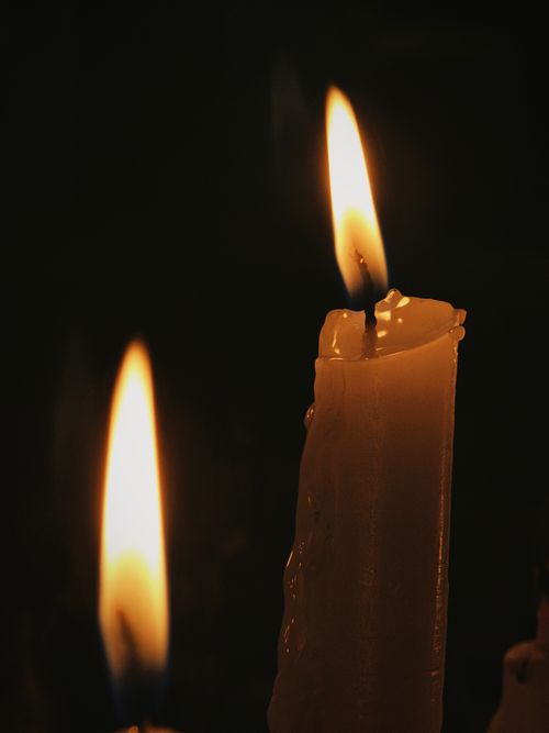 Free Soft, flickering candlelight creates a warm, intimate ambiance in the dark. Stock Photo