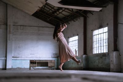 Reference: dancer mid-turn in a derelict industrial hall — photo by Jansel Ferma on Pexels