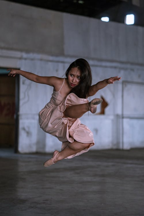Woman In Pink Dress Jumping
