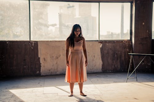 Woman Standing Inside An Abandoned Building