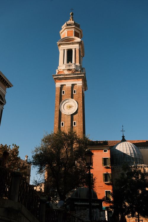 Free Classic bell tower against a clear sky in Venice, featuring iconic Venetian architecture. Stock Photo