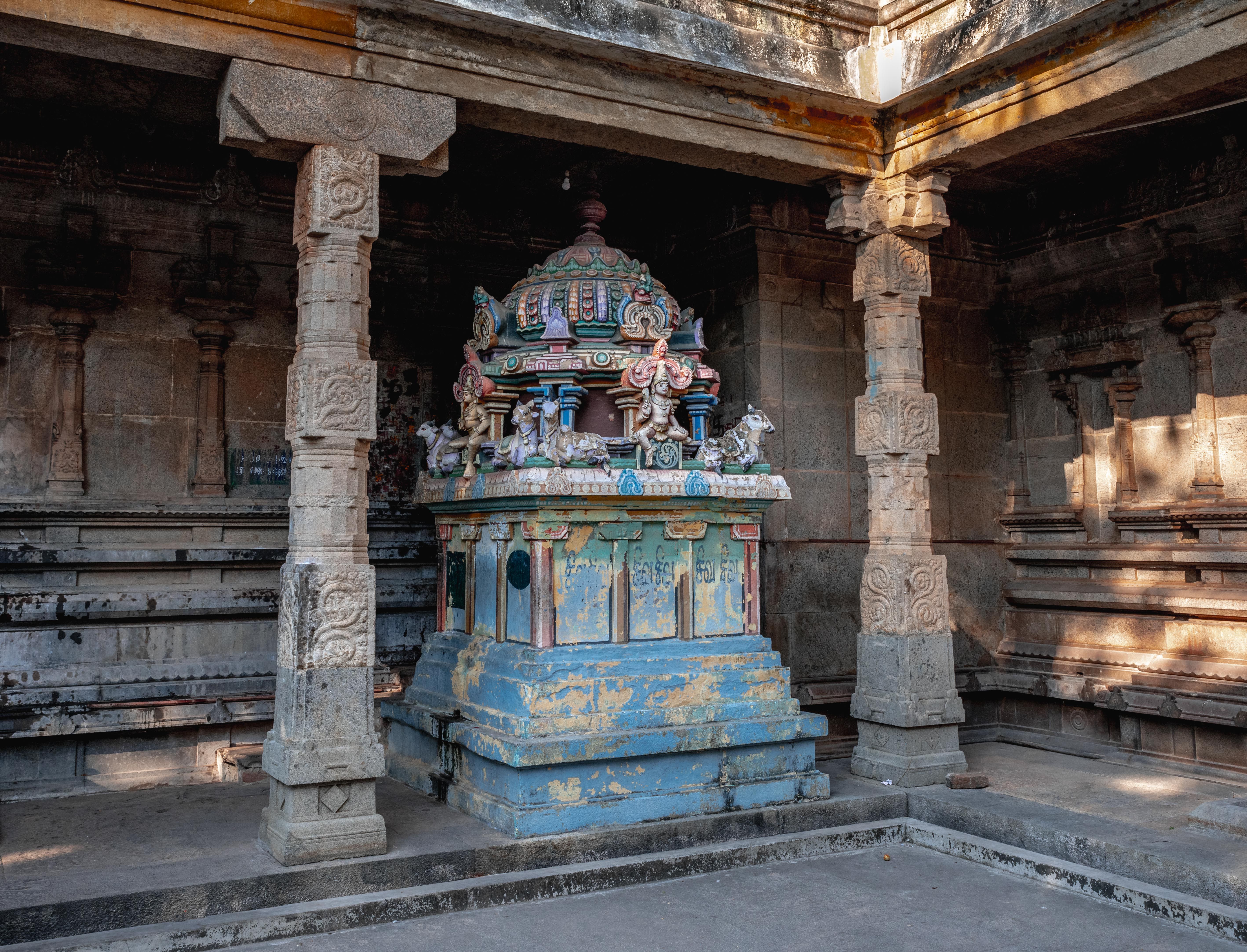 Detailed view of a colorful shrine inside a traditional temple in Kumbakonam, Tamil Nadu, India.