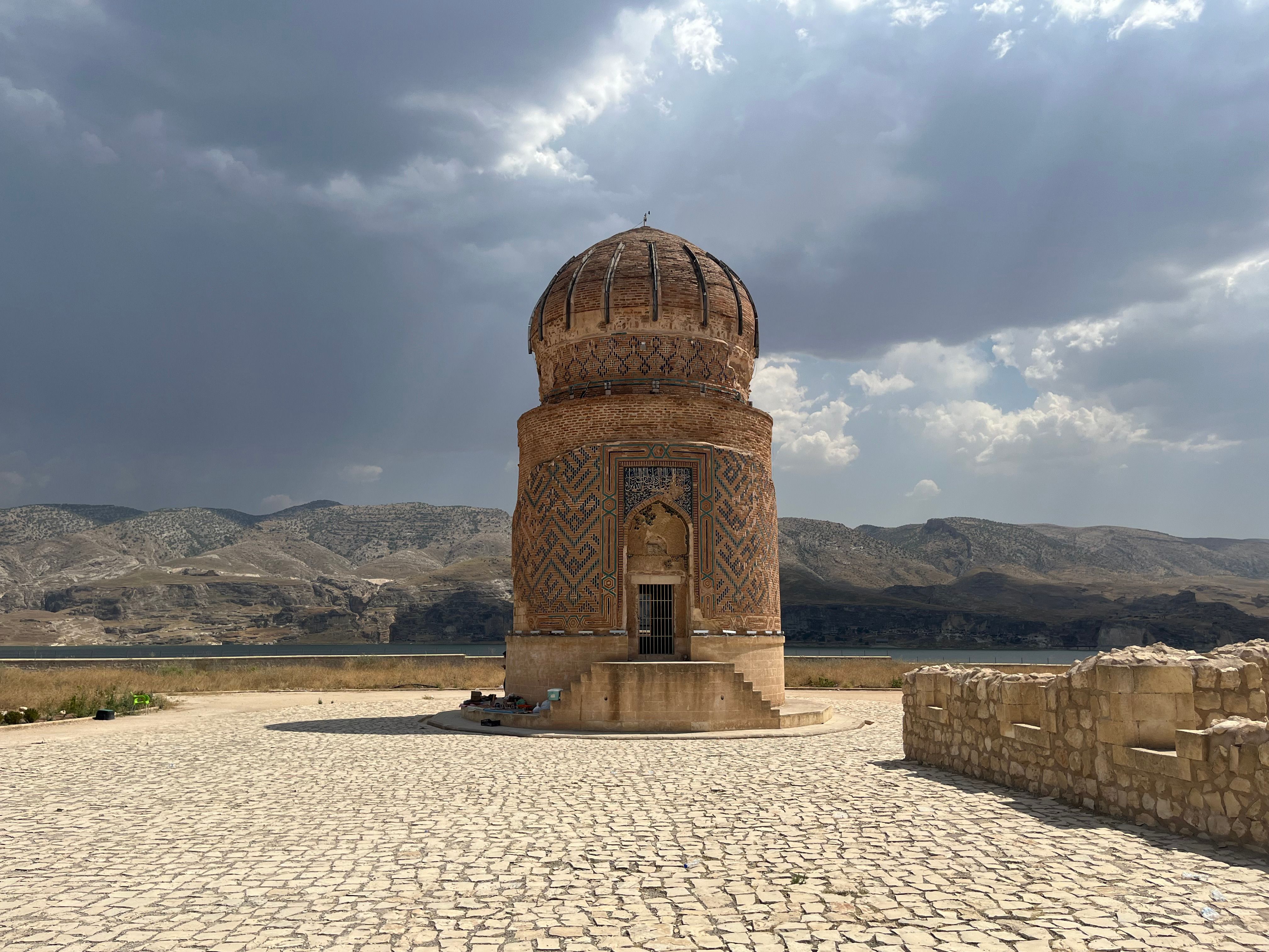 Majestic view of Zeynel Bey Tomb under dramatic skies in Batman, Türkiye.