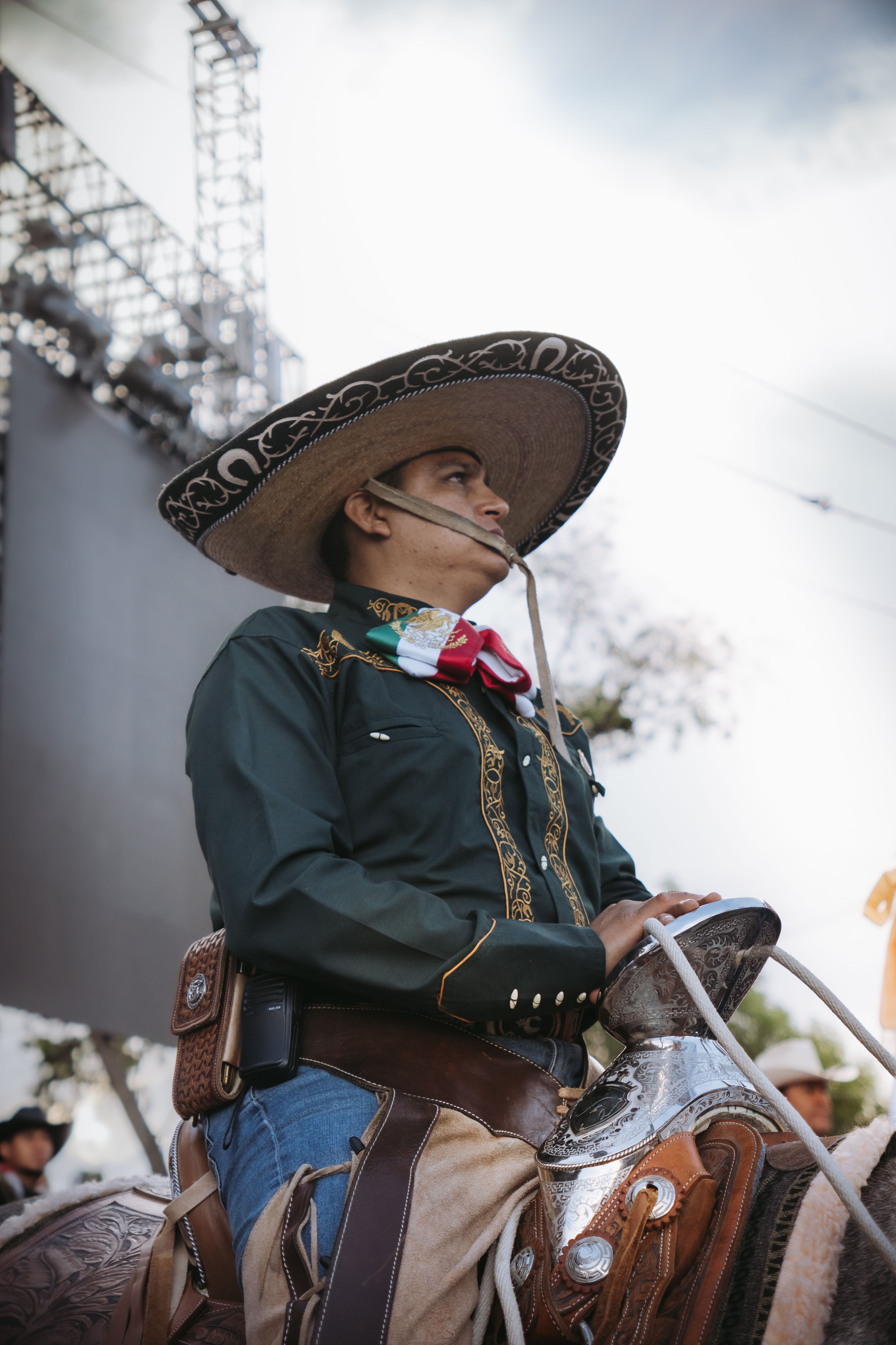 A charro in traditional Mexican attire riding a horse during a festival in Dolores Hidalgo, Guanajuato.