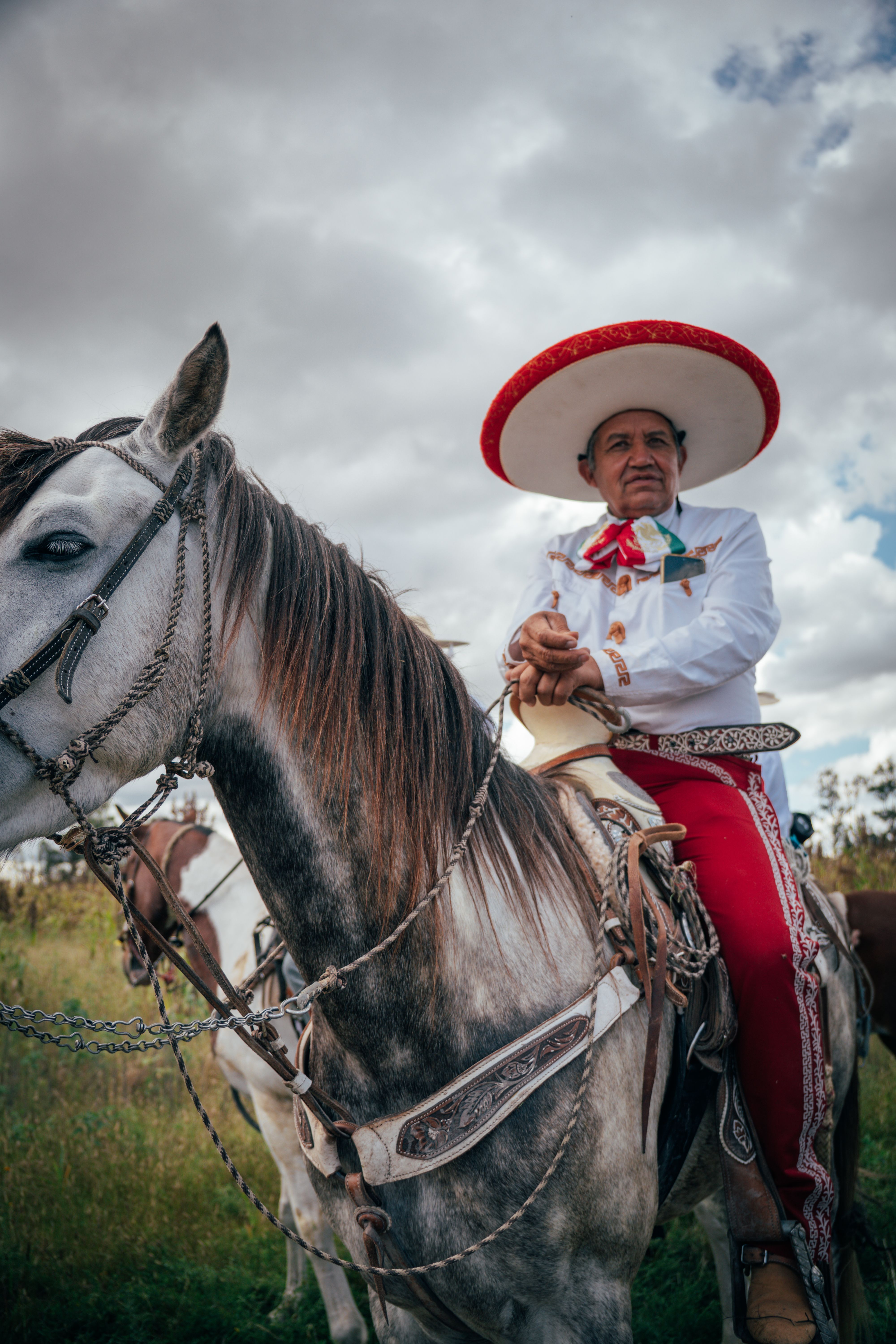 A charro in traditional attire riding a horse during a festival in Dolores Hidalgo, Mexico.