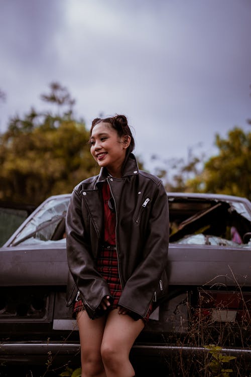 Free Woman In Black Leather Jacket Leaning On A Car Stock Photo