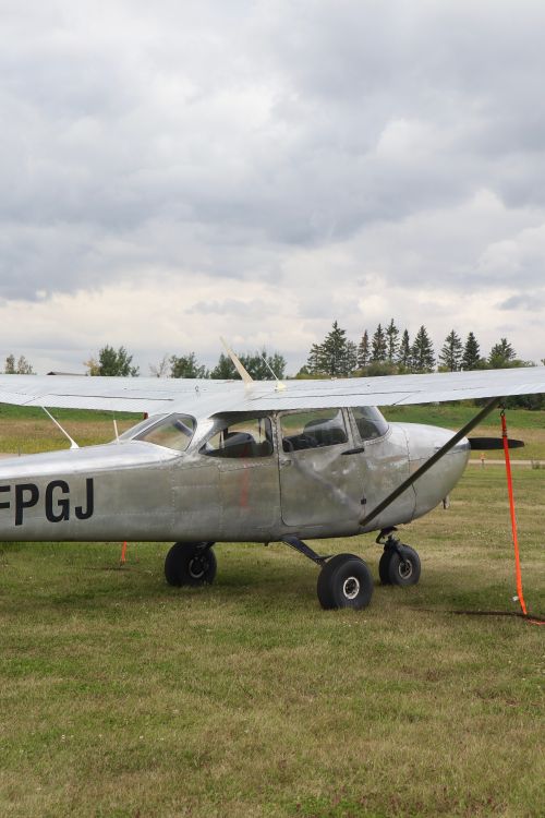 Free A classic airplane parked outdoors in Sherwood Park, AB, Canada, with a cloudy sky overhead. Stock Photo