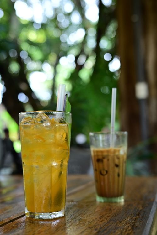 Free Two refreshing iced beverages on a wooden table outdoors, perfect for a summer day. Stock Photo