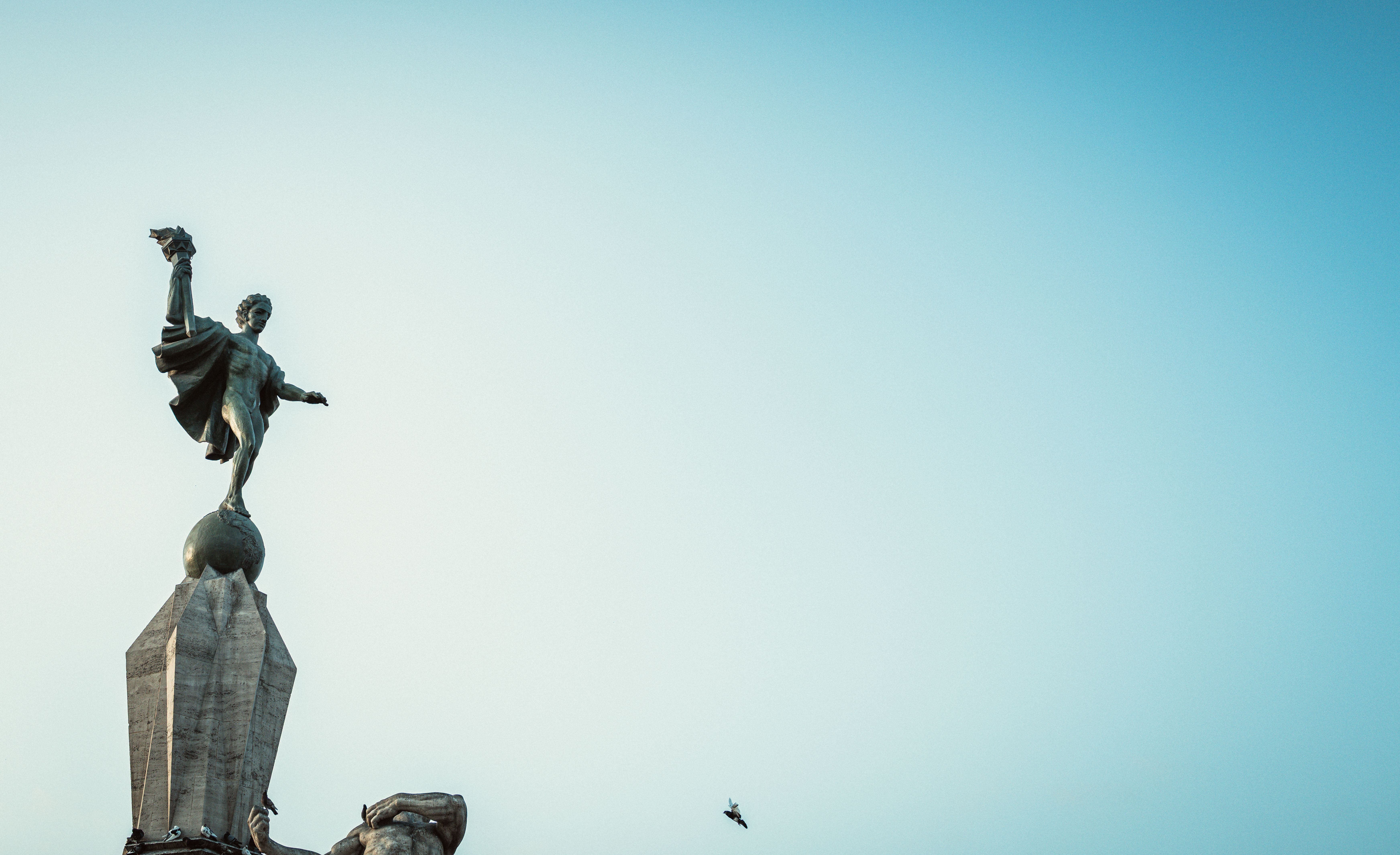A statue in Trujillo, Peru, stands prominently against a clear blue sky, offering a serene view.