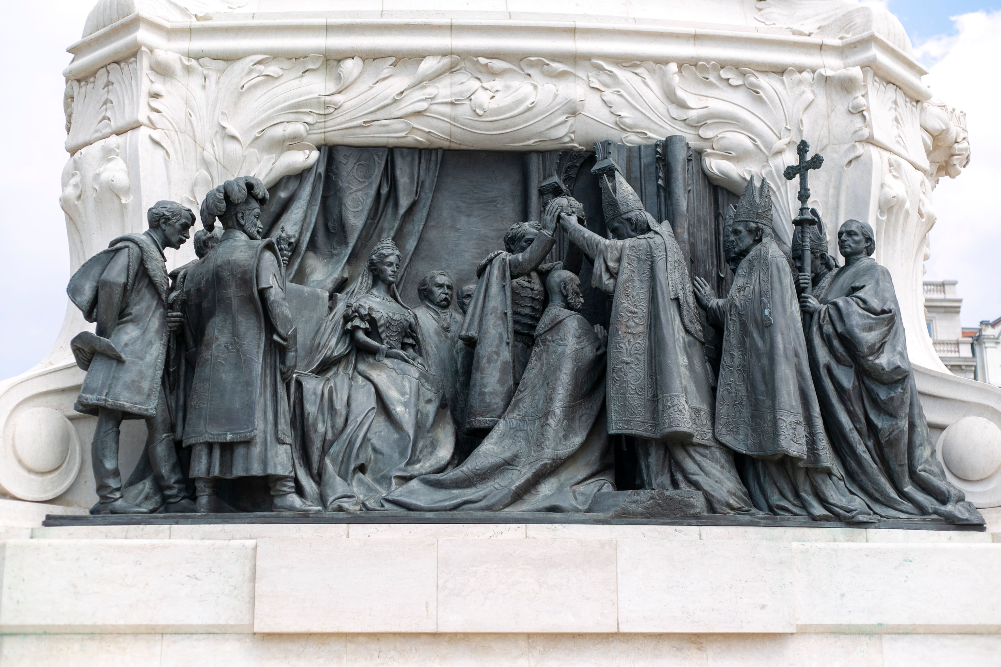 Sculptural detail of a historical monument in Budapest showcasing an ornate ceremonial scene.