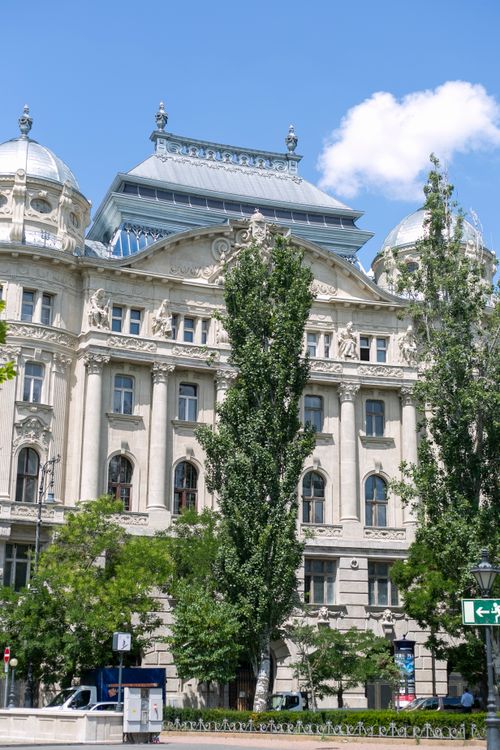 Free Exterior view of a historic building in Budapest, showcasing Neo-Renaissance architecture under a clear blue sky. Stock Photo