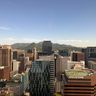 A bright, modern view of the Seoul skyline and business district under a clear blue sky.