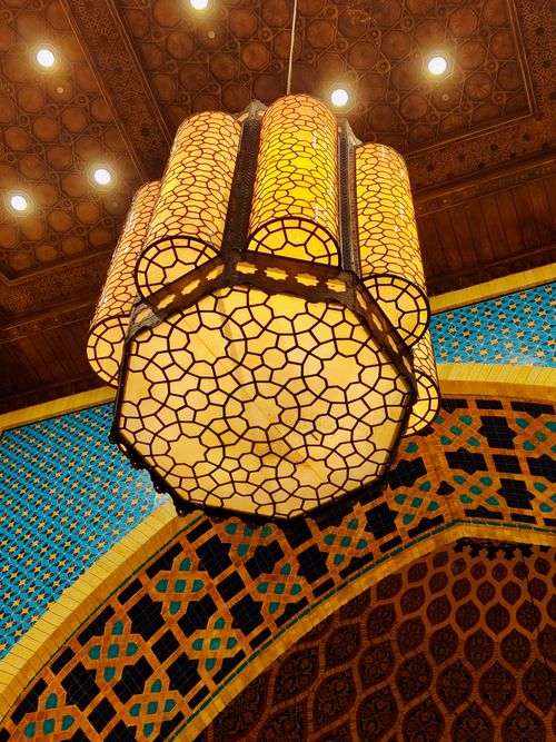 Free Intricate Islamic geometric lantern inside Dubai Mall, UAE, showcasing vibrant patterns and artistic design. Stock Photo