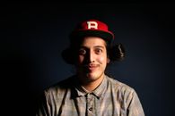 Man Wearing Red Fitted Cap and Brown and Gray Plaid Collared Hsirt