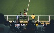 在体育场的比赛中，足球运动员换人，观众也参与其中