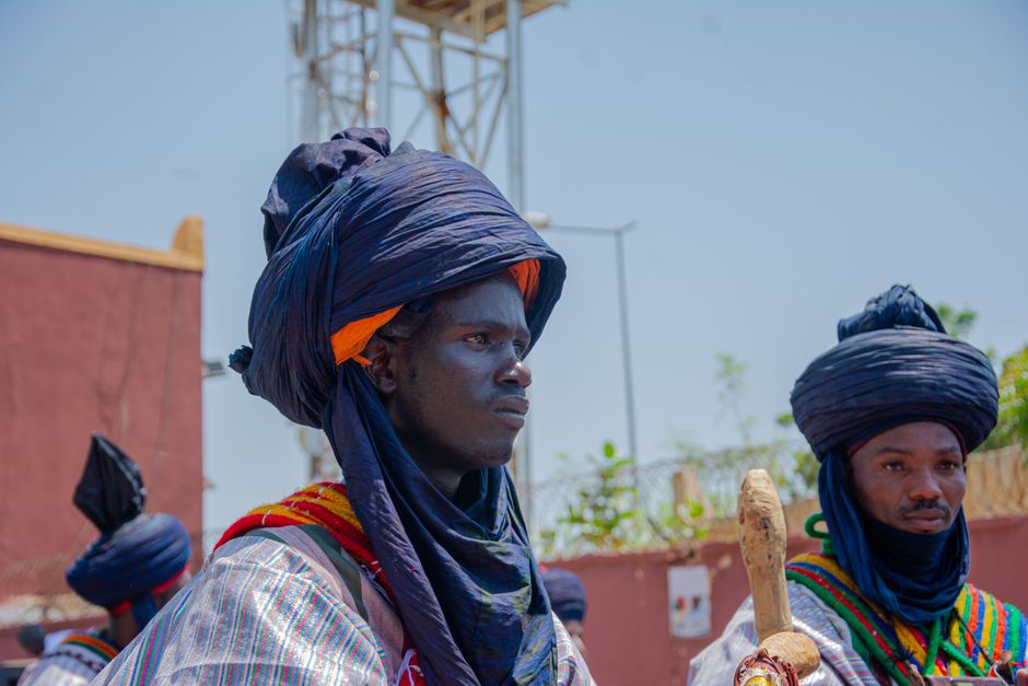 Men in traditional Tuareg attire at a cultural parade, Niamey, Niger.