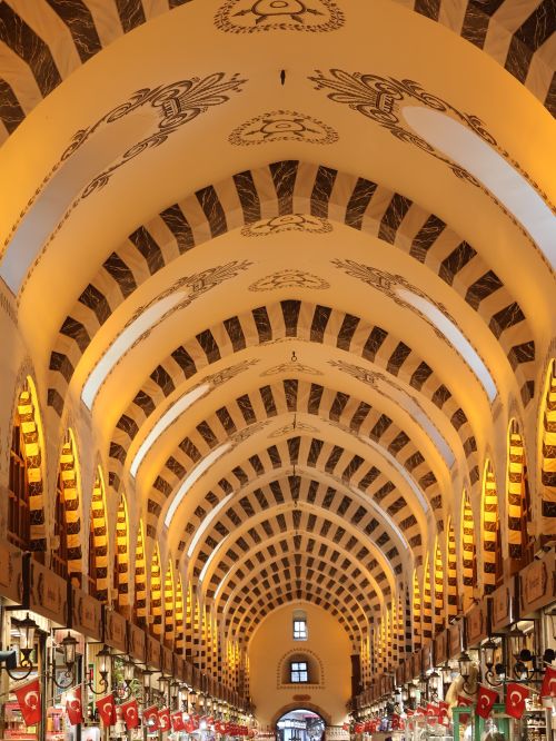Free Stunning intricate ceiling of a Turkish bazaar with illuminated arch design. Stock Photo