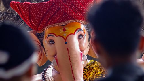 Free Vibrant Ganesh idol at a Hindu festival with devotees observing. Stock Photo