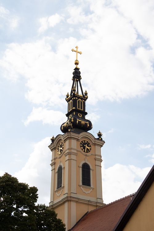 Free A striking church tower with clock and cross against a blue sky in Belgrade, Serbia. Stock Photo