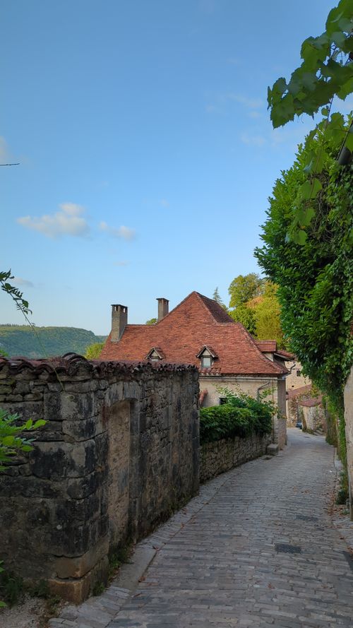 Free Explore the picturesque cobblestone alley in Saint-Cirq-Lapopie, a beautiful village in Occitanie, France. Stock Photo
