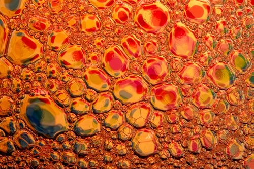 Free Captivating close-up of multicolored soap bubbles creating dazzling abstract art. Stock Photo