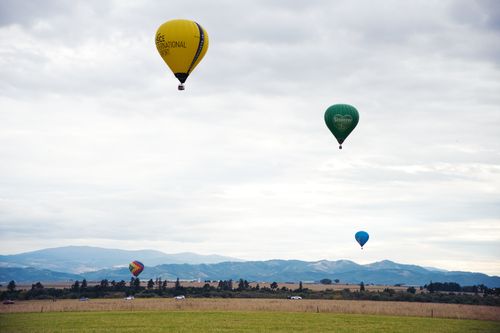 Free Vibrant hot air balloons in the sky over Poprad, Slovakia's scenic landscape. Stock Photo