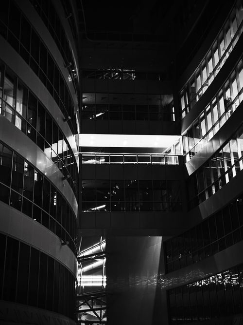 Free Dramatic black and white photo of a modern building's interior with strong geometric patterns. Stock Photo