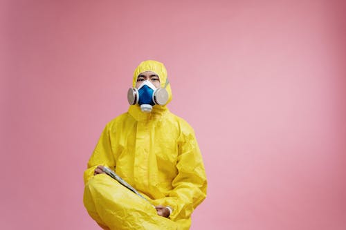 Person Wearing Yellow Protective Suit