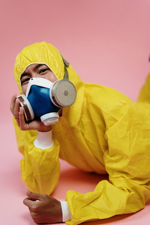 Person In Yellow Protective Suit And Mask