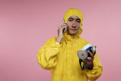Man in Coveralls Talking on Phone