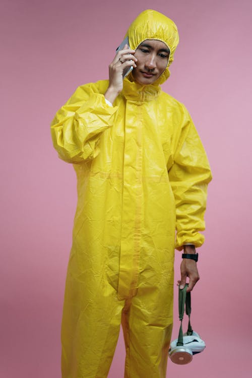 Free Man in Coveralls Talking on Phone Stock Photo
