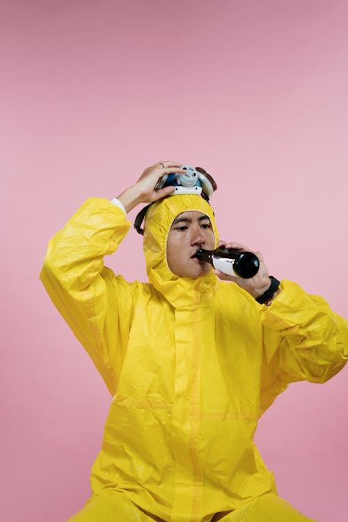 Free Man in Coveralls Drinking Beer Stock Photo