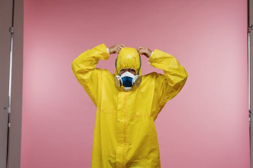 Free Man Putting on Coveralls Stock Photo